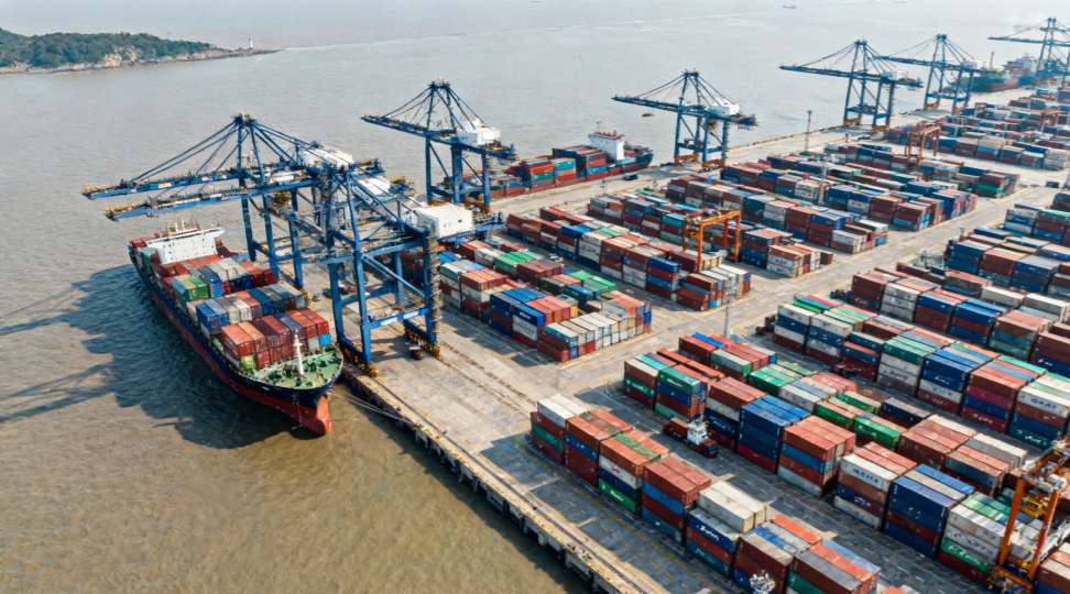 A realistic view of Ningbo Port showing cargo ships and container operations, illustrating the starting point of shipping from Ningbo to Vancouver.
