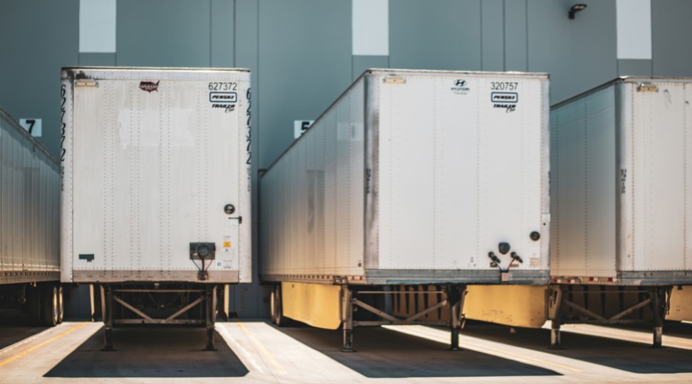 Freight trailers positioned at loading bays, showing fast cross docking and outbound transfer.